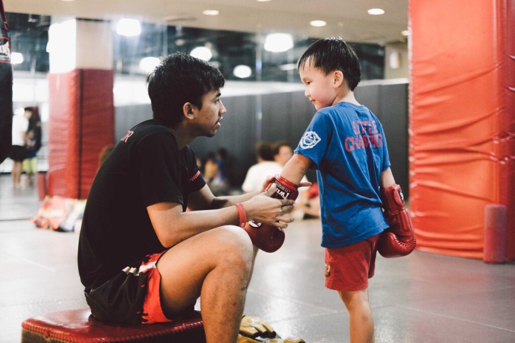 Multiple-time Muay Thai World Champion Penek Sitnumnoi teaches kids at Evolve MMA.