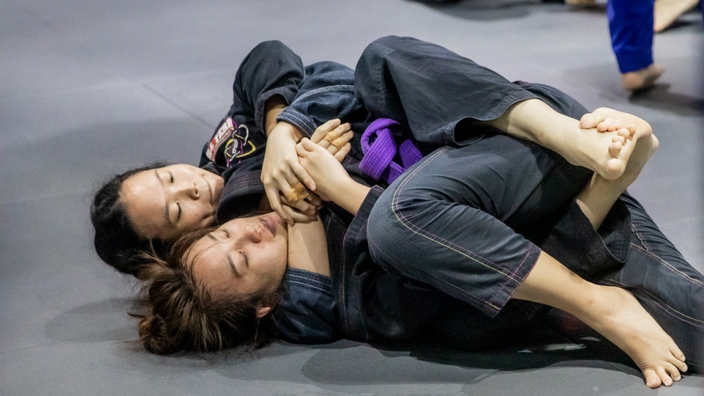 BJJ student taking the back of another student