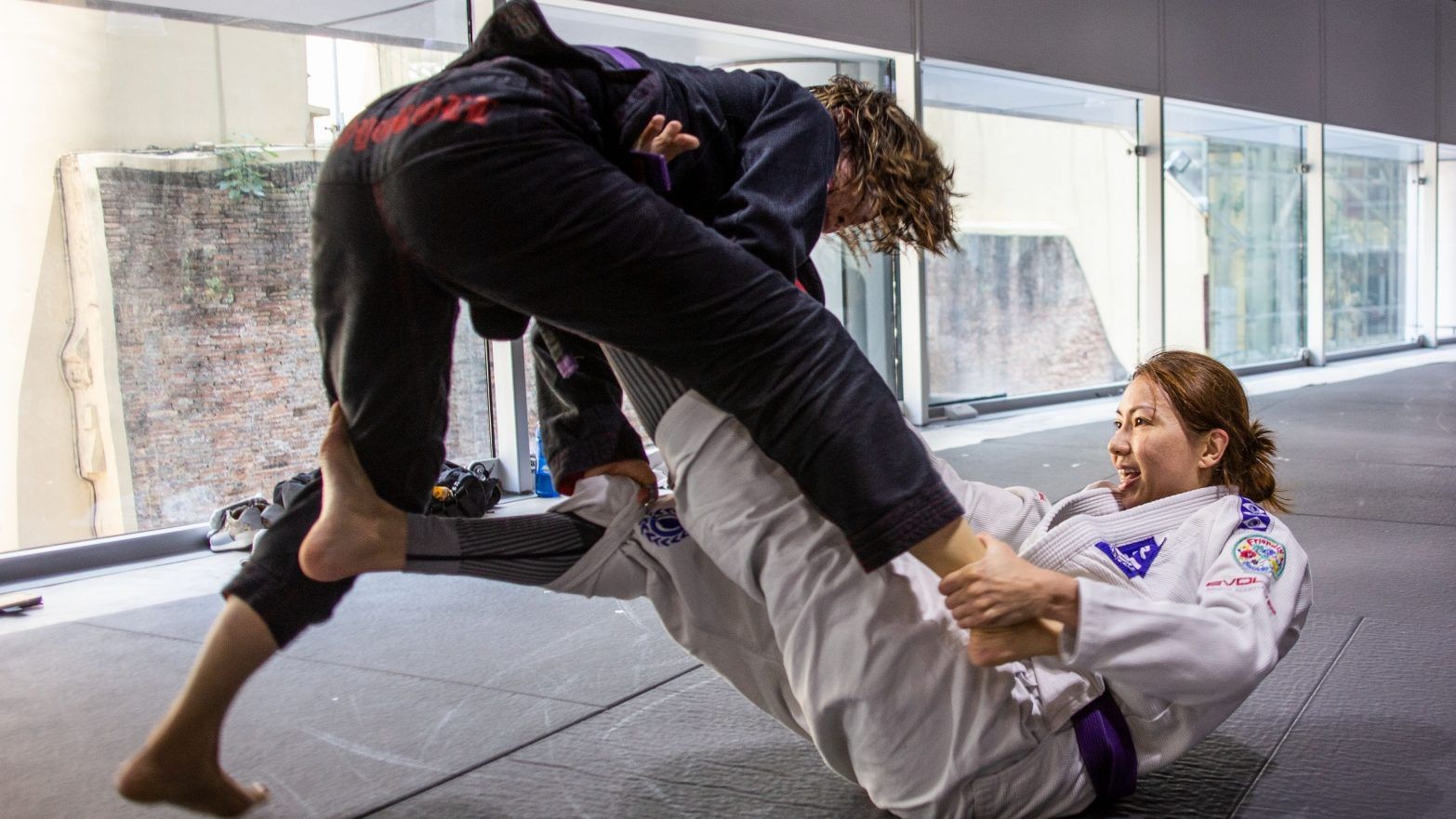 Two female students sparring in a BJJ class