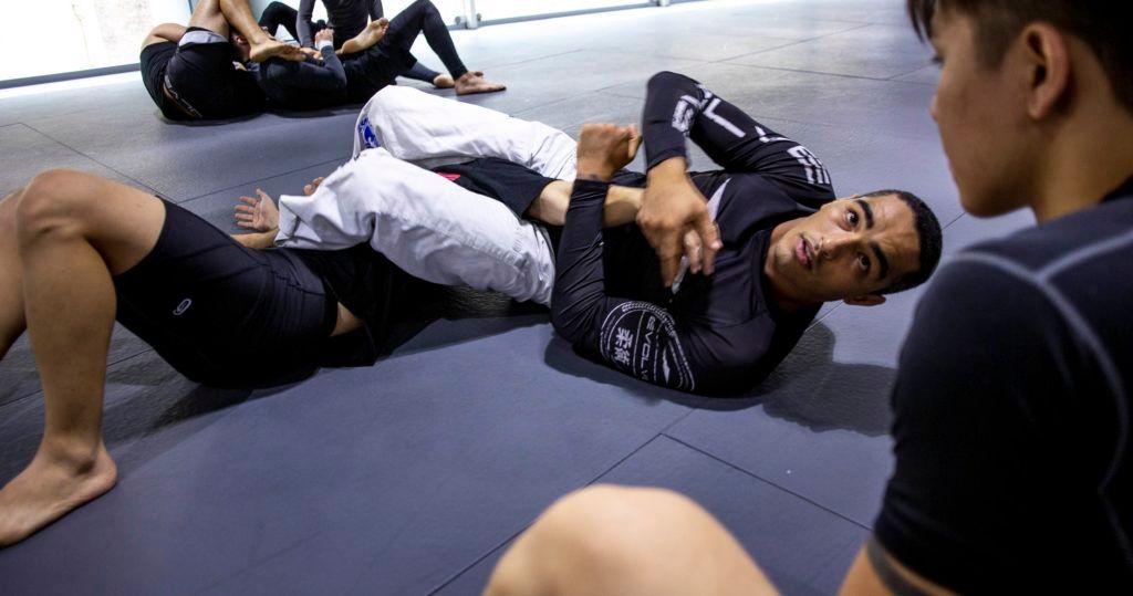 a person performing an armbar in BJJ