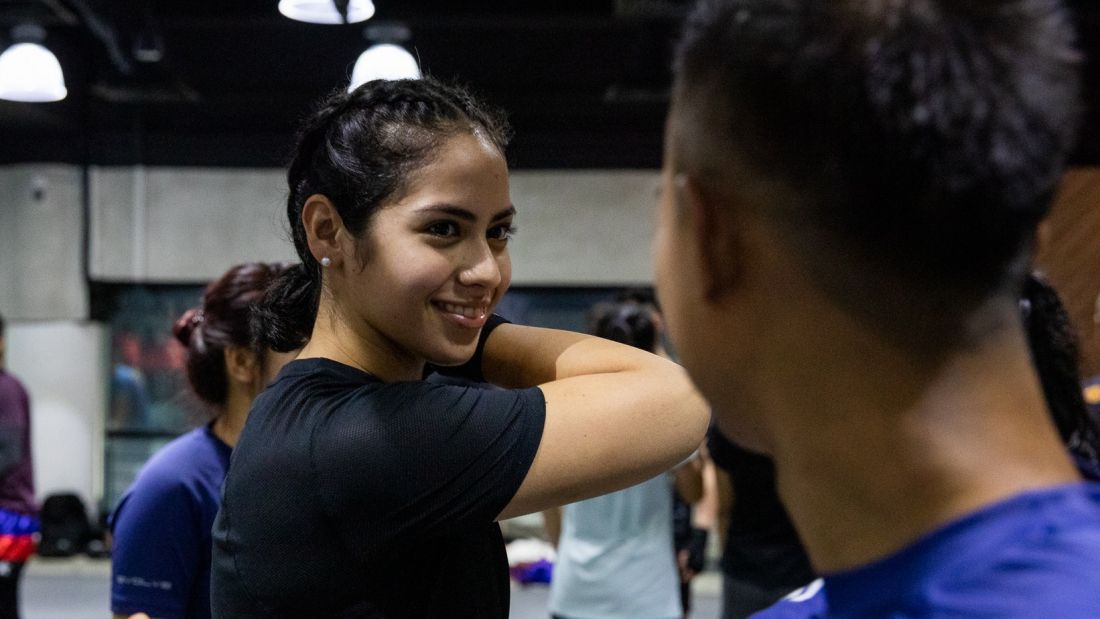 A martial arts student smiling at the gym