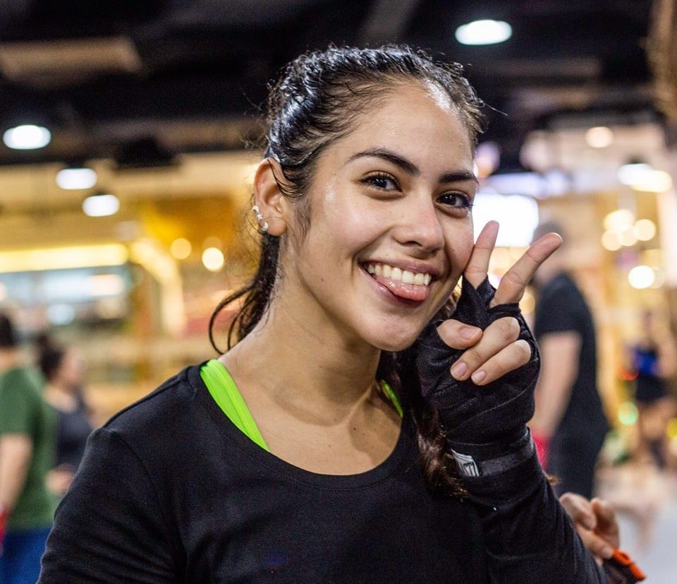 A Muay Thai student poking her tongue out