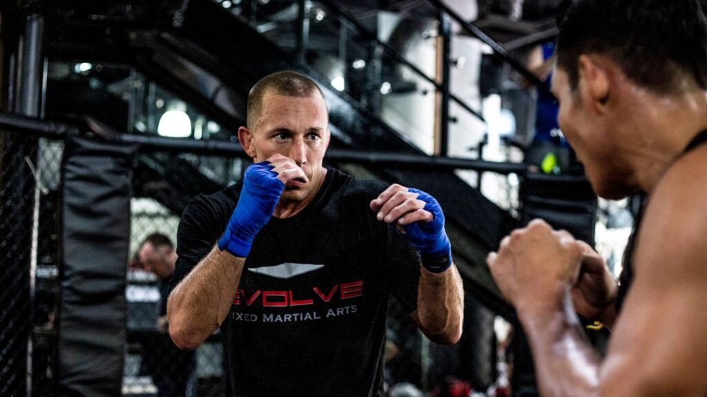 Georges St. Pierre wearing blue hand wraps at Evolve MMA