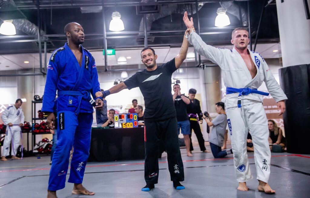 A BJJ competitor with his had raised