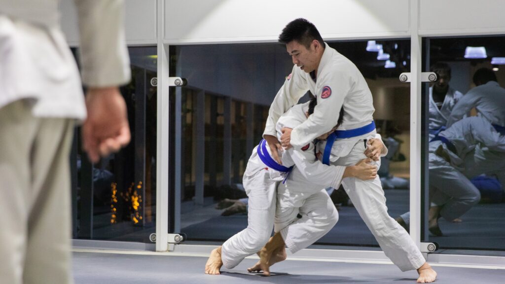 Two BJJ students practicing a takedown