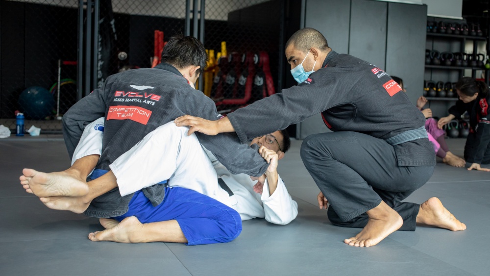 bjj students rolling with closed guard
